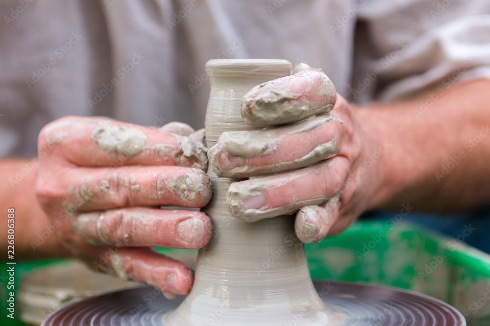 hands sculpt clay