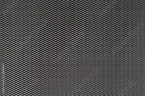 The photo of dark gray aluminum grid of cooking hood's filter that taking as background.