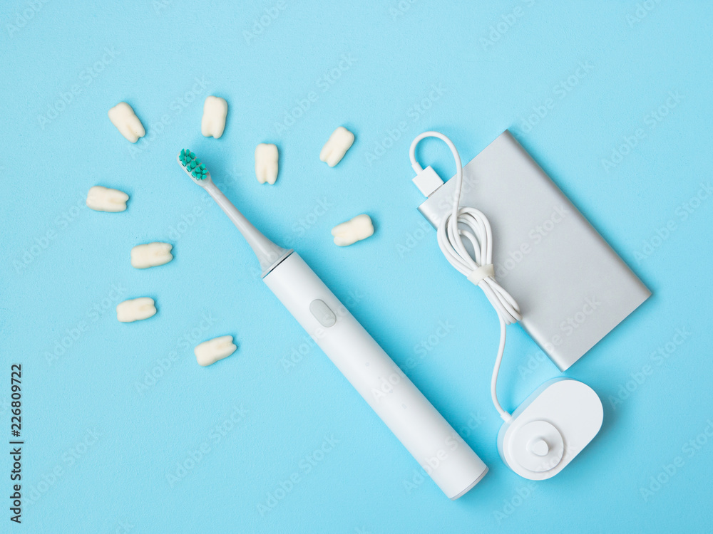 Smart electric toothbrush. Charges through powerbank and is controlled by the application on the smartphone. Modern technology for health. Healthy teeth. Dentistry. Medical robot. Smart electric toothbrush. Charges through powerbank and is controlled by the application on the smartphone. Modern technology for health. Healthy teeth. Dentistry. Medical robot.