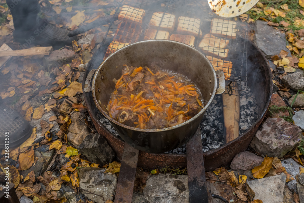 Autumn picnic. Cooking on an open fire in the company of friends. Autumn picnic. Cooking on an open fire in the company of friends.