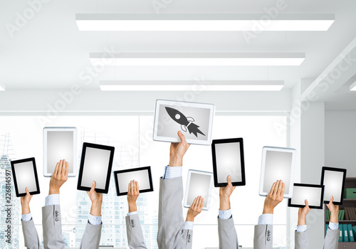 Close of businessman hands in line showing tablet pc with blank screen. Mixed media