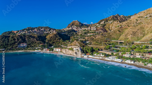 Aerial. View from beach toTaormina. Taormina has been a tourist destination since the 19th century. Located on east coast of the island of Sicily, Italy.