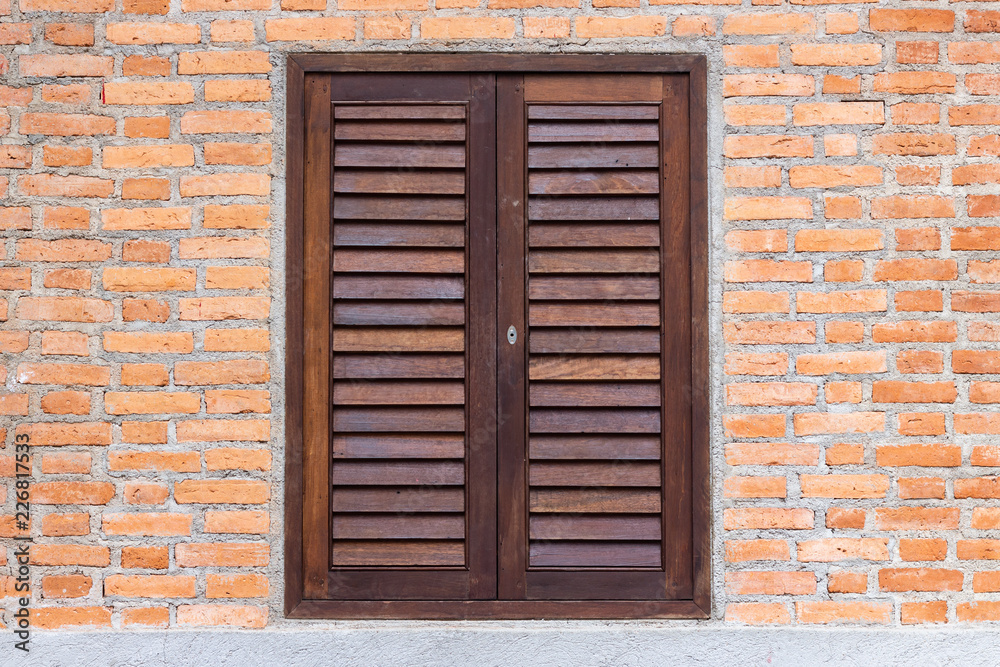 Wooden window on a brick wall