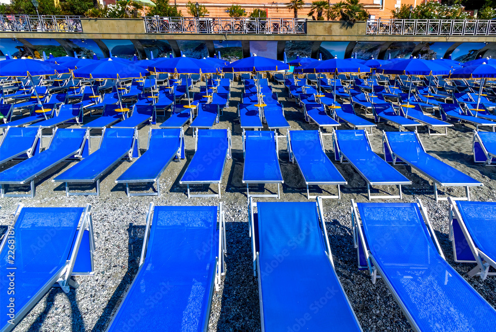 Naklejka premium Blue chairs on the beach of Monterosso Al Mare Italy 