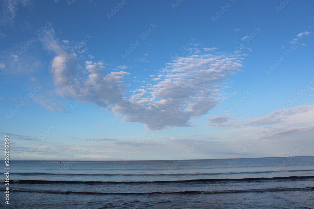 Sea and brigth blue sky with white clouds 