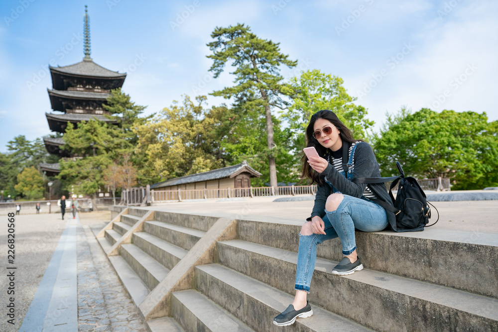elegant lady sitting on stairs using smartphone elegant lady sitting on stairs using smartphone