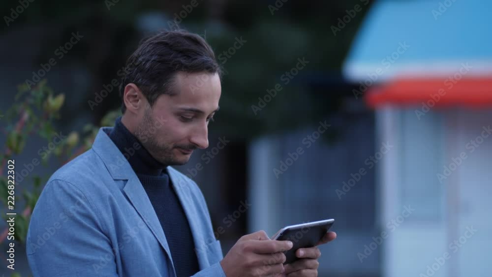 young attractive Caucasian man uses tablet young attractive Caucasian man uses tablet