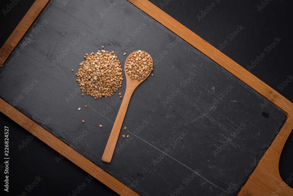 Pile of Buckwheat on black granite table Pile of Buckwheat on black granite table