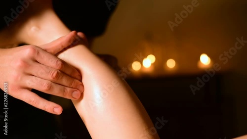 Wallpaper Mural Massage of the lower part of the female leg with oil on the background of candles in a dark room Torontodigital.ca