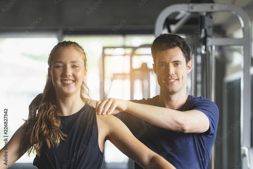 Closed up young woman working out in modern gym, with sun flare effect reflects on equipment. Closed up young woman working out in modern gym, with sun flare effect reflects on equipment.