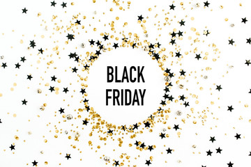 Black Friday sales discount concept in round frame of gold and black confetti. Flat lay, top view festive shopping background.