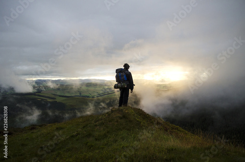 Hiker Watching the Sunset up in the Hills