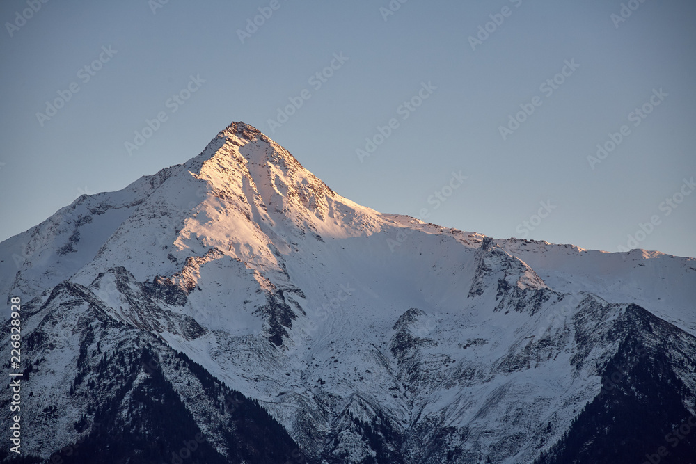 The last rays of sunshine on the west face of Ahornspitze. Shot from the opposite side of the valley at Schwendberg.