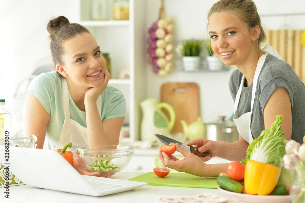 Portrait of girlfriends in the kitchen cook Portrait of girlfriends in the kitchen cook