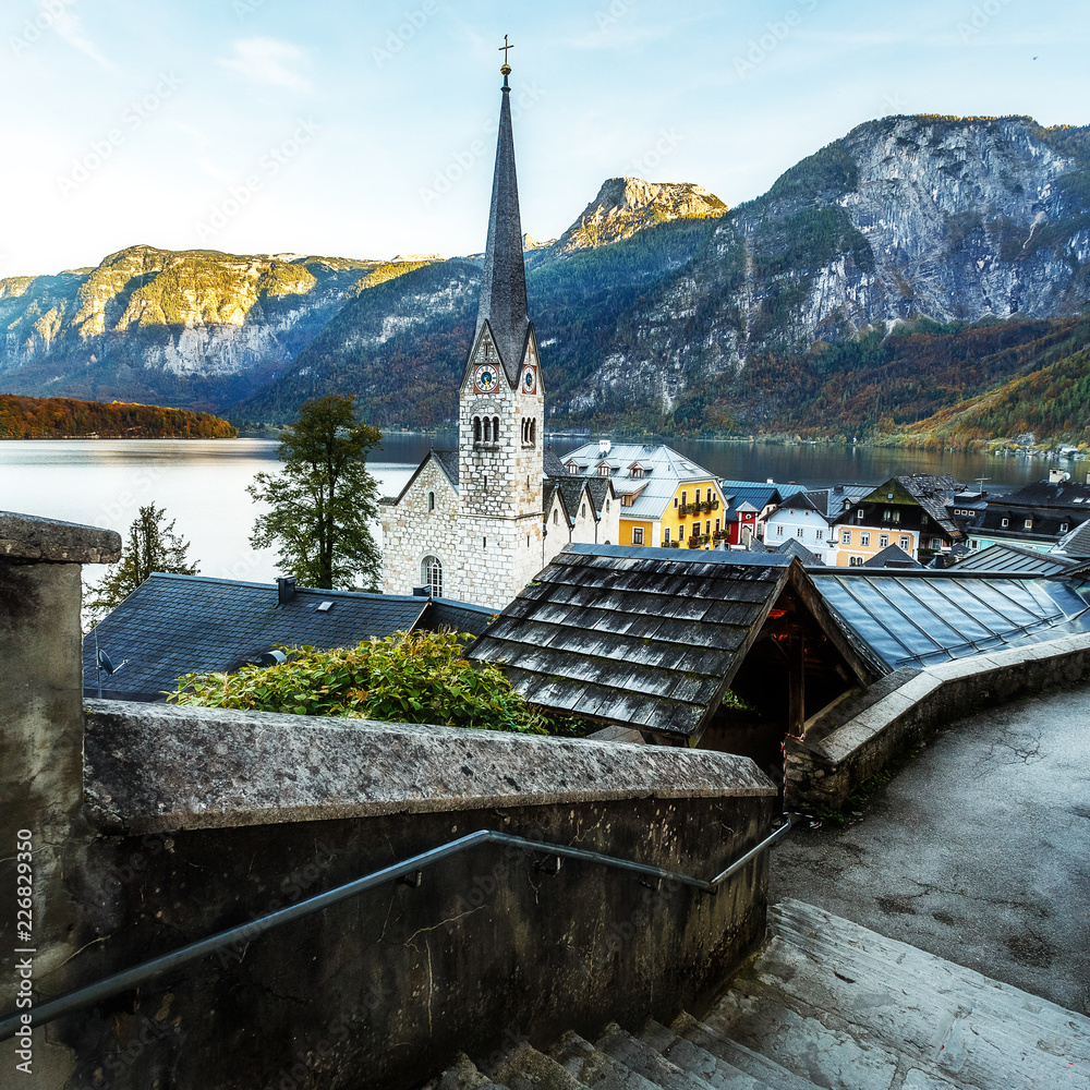 Awesome view on the lake Hallstatter and Hallstatt Lutheran Church. Wonderful Colorful Sunset in famous Hallstatt alpine village, in the Austrian Alps in autumn. Instagram filter