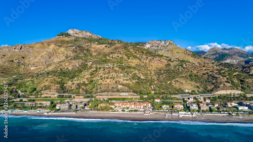 Aerial. Beach view near Taormina. Taormina has been a tourist destination since the 19th century. Located on east coast of the island of Sicily, Italy.