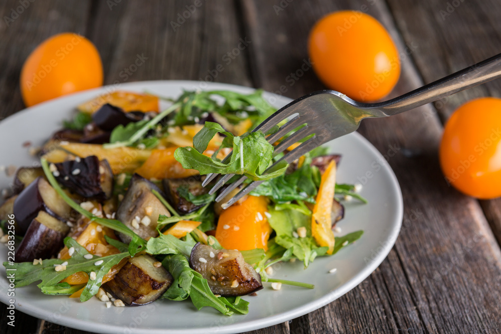 Healthy salad with grilled eggplant, greens and arugula.