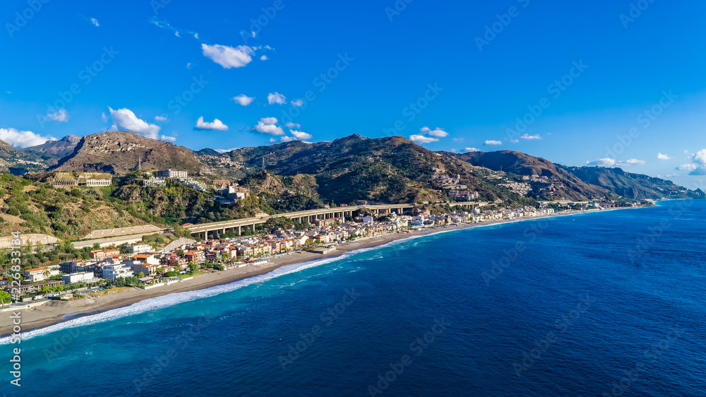 Aerial. Beach view near Taormina.  Taormina has been a tourist destination since the 19th century. Located on east coast of the island of Sicily, Italy.