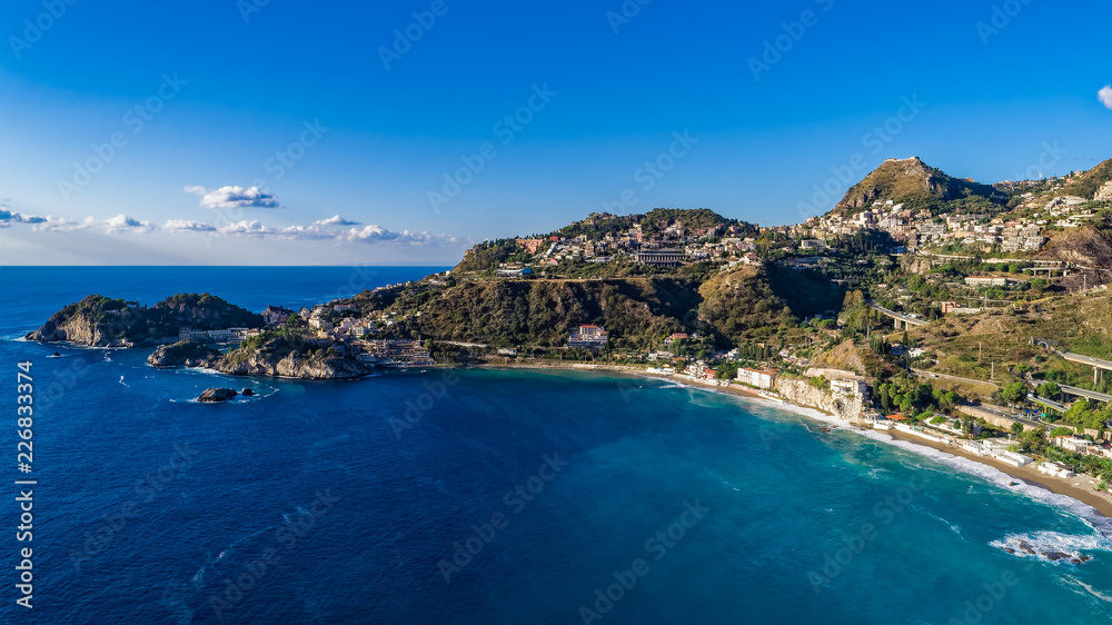 Aerial. View from beach toTaormina.  Taormina has been a tourist destination since the 19th century. Located on east coast of the island of Sicily, Italy.
