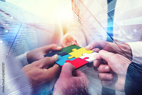 Business people join puzzle...