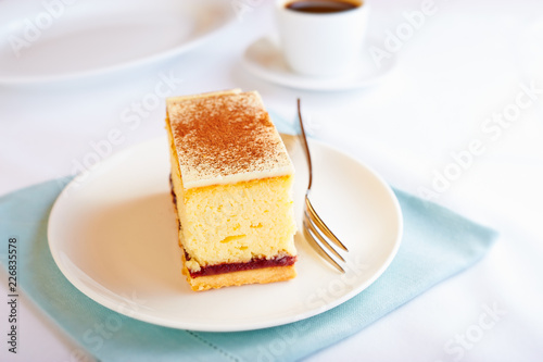 Cheesecake with white chocolate and cocoa and a cup of coffee. White background. Copy space. 