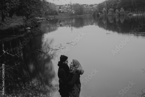 Black and white portrait of couple walking in the wilderness. Young people in love. Travel and tourism.
