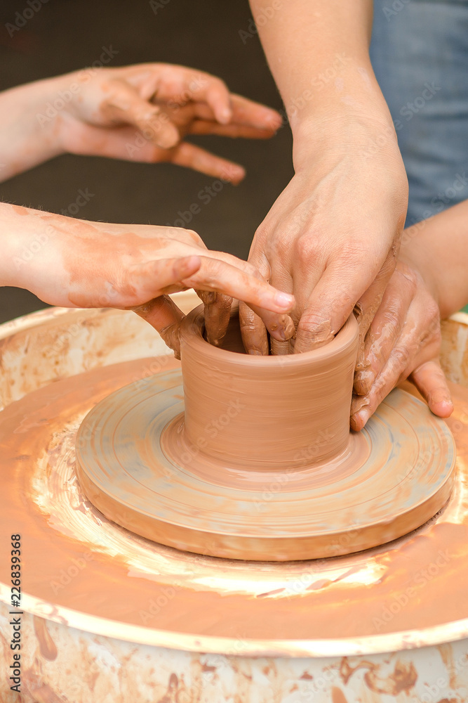 A close-up of the child learns to knead the clay