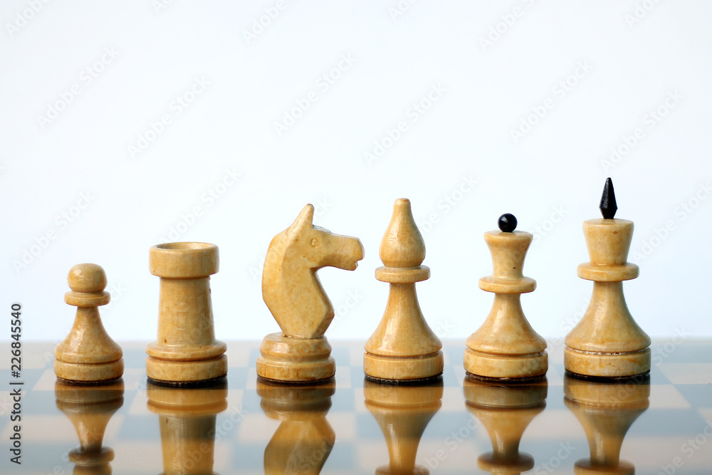 Chess pieces on white background.