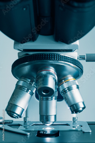 Close-up shot of modern microscope with sample slide at laboratory.