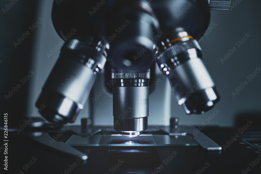 Close-up shot of modern microscope with sample slide at laboratory. Close-up shot of modern microscope with sample slide at laboratory.
