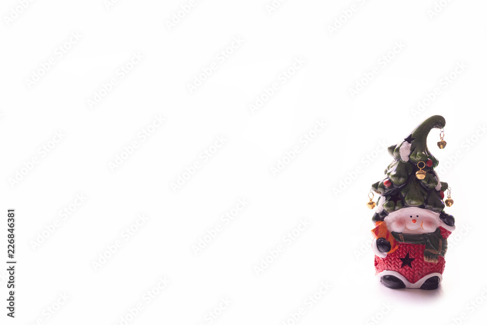 Bright toy dwarf with a cheerful face and a bell on a hat on a white background. New year, Christmas decoration.