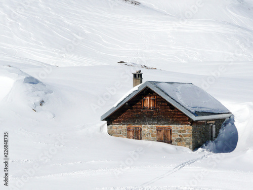 Cow Stable sunk in the deep snow on the Alps mountain in winter © Yü Lan