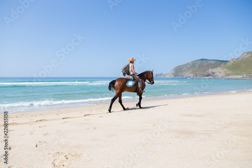 Man riding a horse at the beach at the atlantic ocean