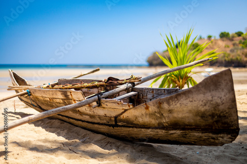 Madagascan pirogue boats at sunset on Nosy Be, Madagascar. Blurred background. photo