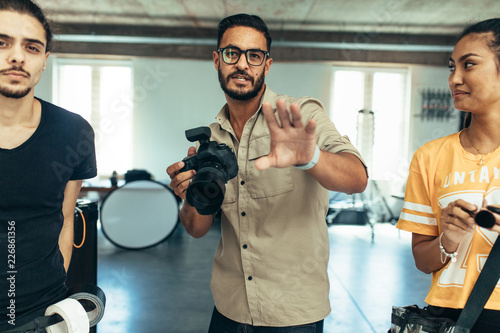 Photographer with his team during a photo shoot in a studio