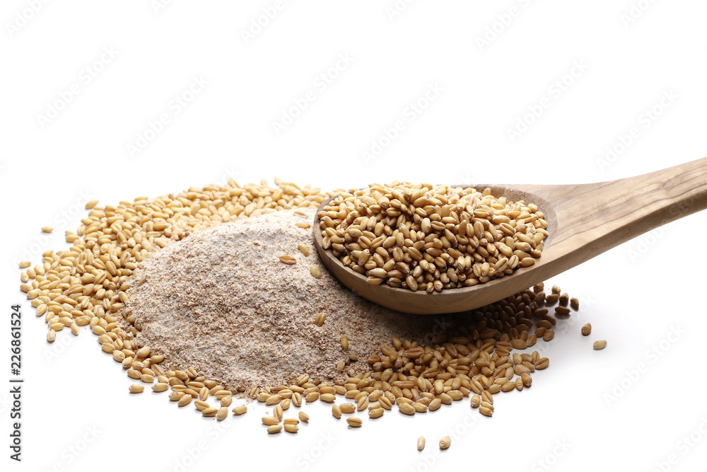 Integral flour pile and wheat grains in wooden spoon isolated on white background Integral flour pile and wheat grains in wooden spoon isolated on white background