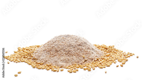 Integral flour pile and wheat grains isolated on white background