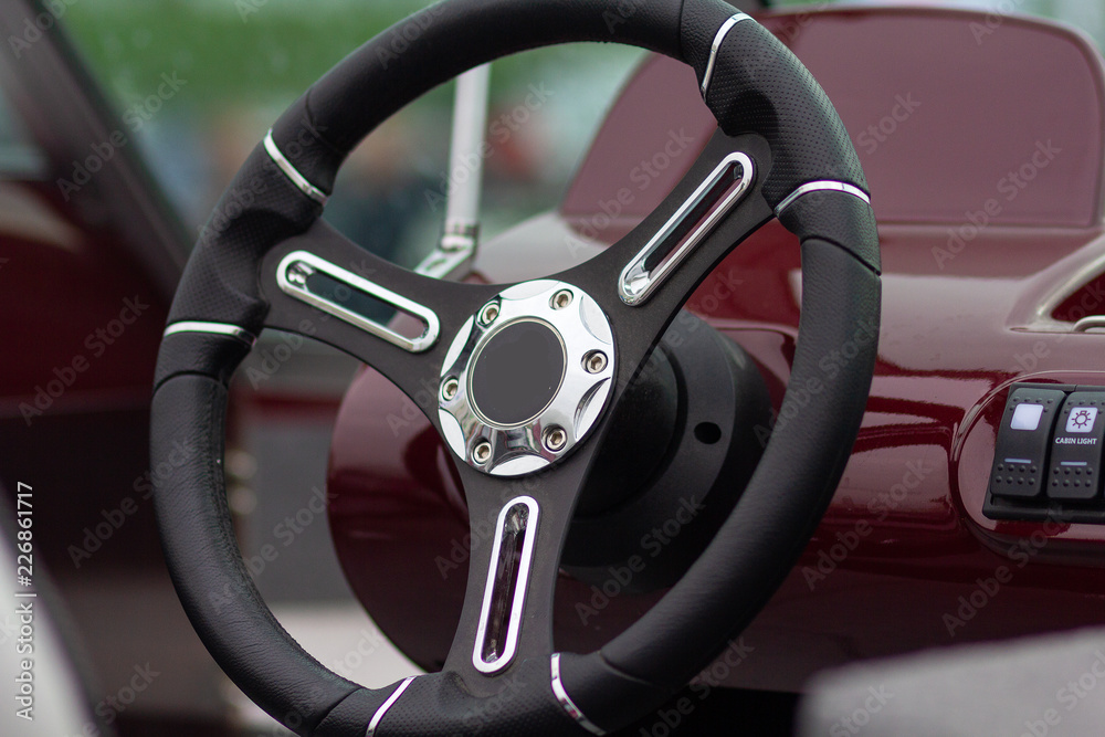 Steering wheel of a motor boat closeup. Transport