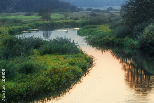 Summer landscape with meanderin river in countryside.