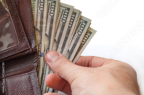 Man taking dollars out of wallet.