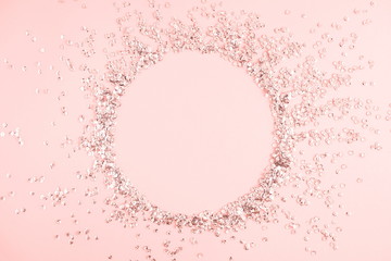 Festive pink background. Shining sequins on light pink pastel background. Christmas. Wedding. Birthday. Happy woman's day. Mothers Day. Valentine's Day. Flat lay, top view, copy space. 