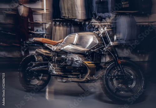 Photo of a retro sports motorbike at the men's clothing store with motion light effect.
