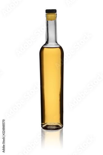 glass bottle of the matured brandy or whisky with reflection on a white background