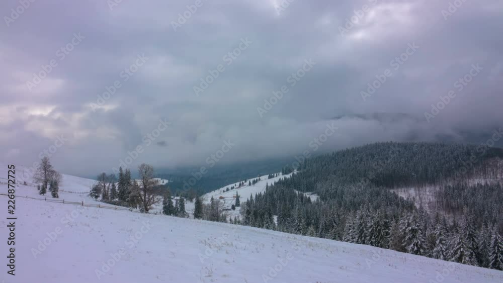 The Winter Mountain Forest on the Background of Dramatic Cloudy Sky. Timelapse. 4K. The Winter Mountain Forest on the Background of Dramatic Cloudy Sky. Timelapse. 4K.
