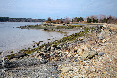 Rocky, scenic saltwater shoreline along the Atlantic Ocean at the Goat Island Saltwater Fishing Access area near Portsmouth, New Hampshire in the springtime.  photo