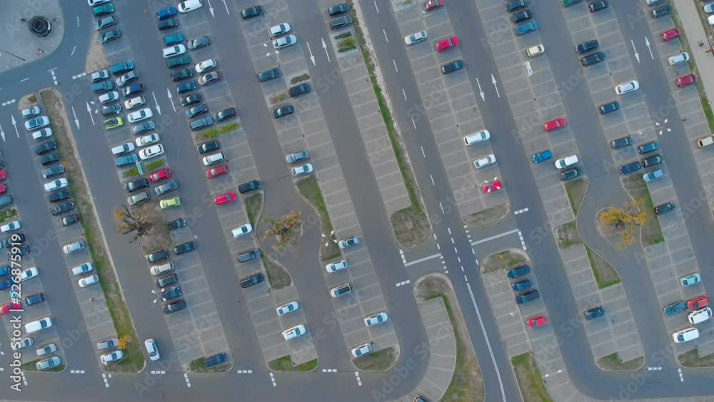 aerial view of large parking lot with parked cars aerial view of large parking lot with parked cars