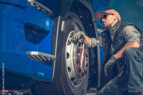 Truck Driver Checking Tires photo
