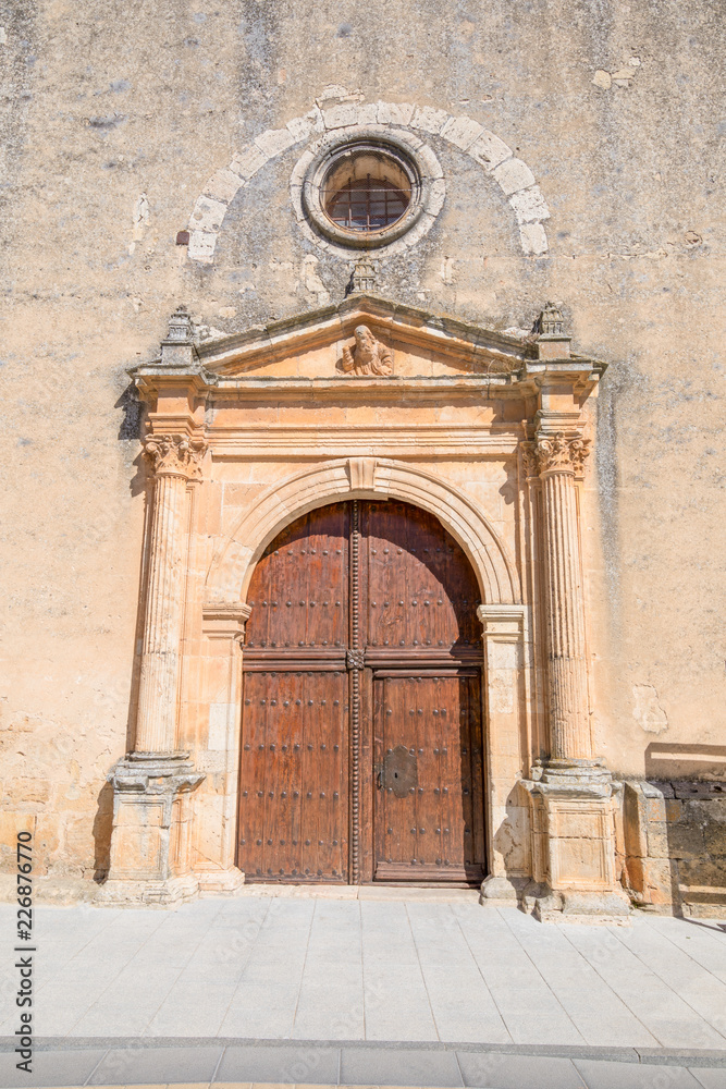 Exterior door, columns and reliefs, in church of Santa Cristina, renaissance style landmark and public monument from sixteenth century, in Burgo de Osma, Soria, Spain, Europe