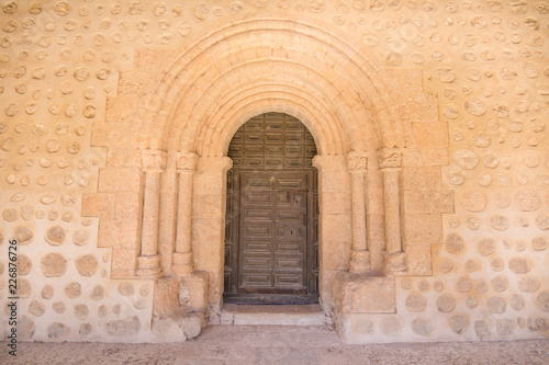 Exterior door, columns and reliefs, in church San Miguel (Saint Michael), romanesque style landmark and public monument from eleventh century, in San Esteban de Gormaz, Soria, Spain, Europe photo