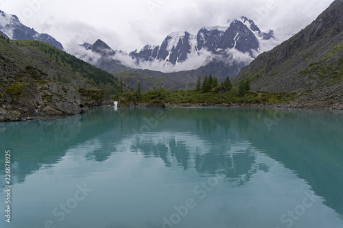 Reflection of mountains in the water. Altai Mountains, Russia.